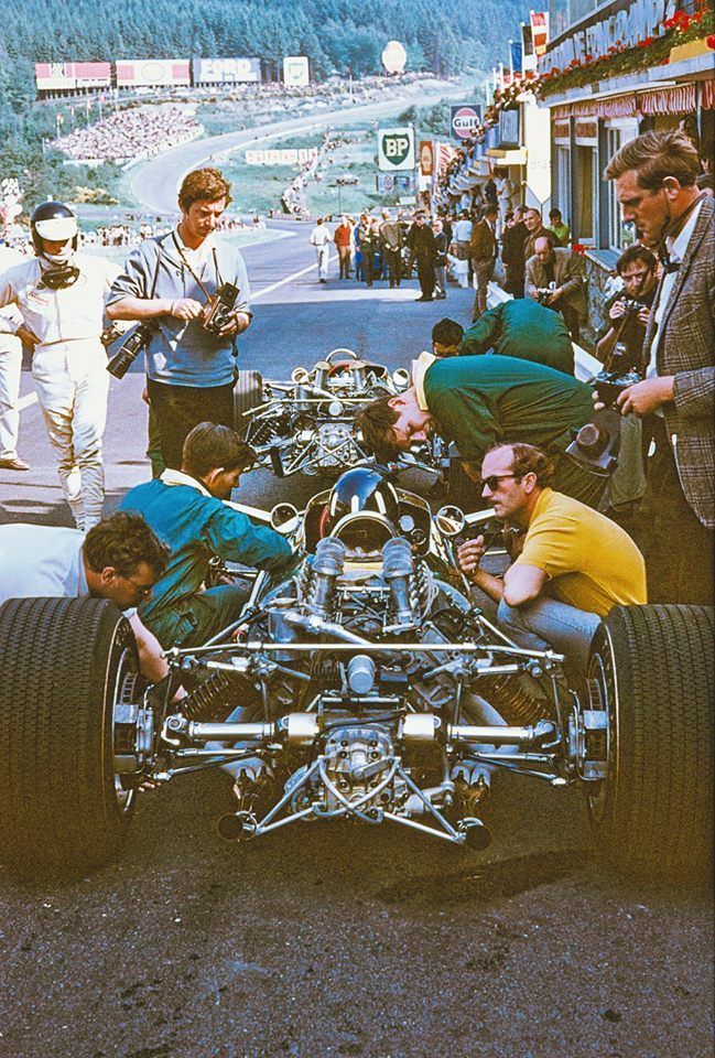 Technical inspection of a race car on a track with people around
